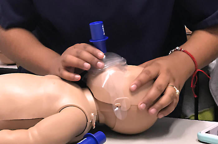 practice CPR on baby mannequin. Learn CPR and Basic Life Support at Friday Night Lights EMS classes